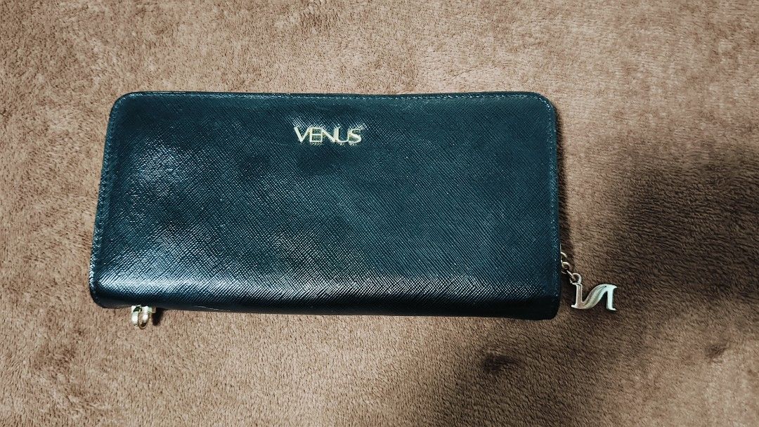 Venus and GG Style Wallets (Category: Wallets & Card holders) located in Manila. Submitted by serenitycarlylle (Listing ID 1463723595, Image 1). Description: - Bundle of 2 zip-around wallets - Includes: Black Venus wallet with charm, Light Purplewallet with GG-style emblem - Features: Multiple card slots and compartments inside each wallet - Condition: Some wear on edges and zippers, as shown in photos - Selling: Both wallets together as a set.