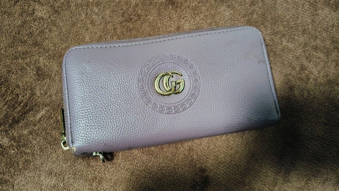 Venus and GG Style Wallets (Category: Wallets & Card holders) located in Manila. Submitted by serenitycarlylle (Listing ID 1463723595, Image 3). Description: - Bundle of 2 zip-around wallets - Includes: Black Venus wallet with charm, Light Purplewallet with GG-style emblem - Features: Multiple card slots and compartments inside each wallet - Condition: Some wear on edges and zippers, as shown in photos - Selling: Both wallets together as a set.
