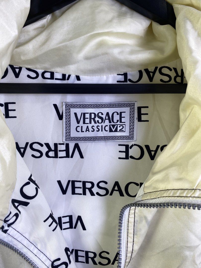 Versace Classic V2 Windbreaker Jacket (Category: Coats, Jackets and Outerwear) located in Manila. Submitted by declutterpromax (Listing ID 1463624861, Image 3). Description: - Cream Versace Classic V2 windbreaker - All-over print lining with Versace logos - Zip-up front - Drawstring hood - Two front pockets - 100% Polyester - Care: Hand wash or dry clean only.