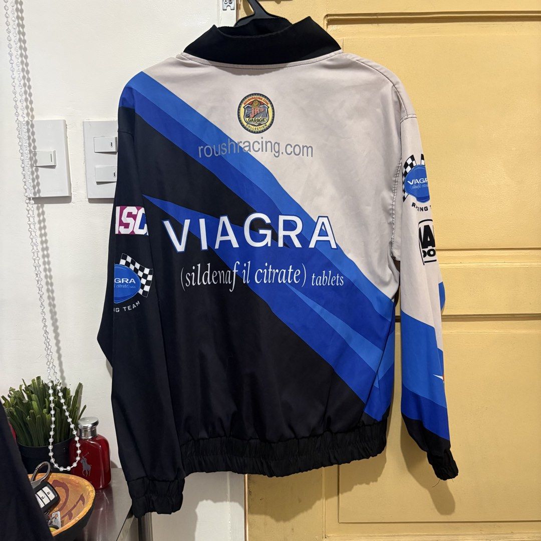Viagra Racing Jacket (Category: Coats, Jackets and Outerwear) located in Makati City. Submitted by sseurekiii (Listing ID 1463721127, Image 2). Description: - Cool racing jacket featuring Viagra and Roush Racing branding. - Includes Ford and other sponsor logos. - Stylish black, blue, and beige colorway. - Convenient zipper closure. - Comfortable ribbed cuffs and hem. - Ideal for racing enthusiasts and unique streetwear fashion..