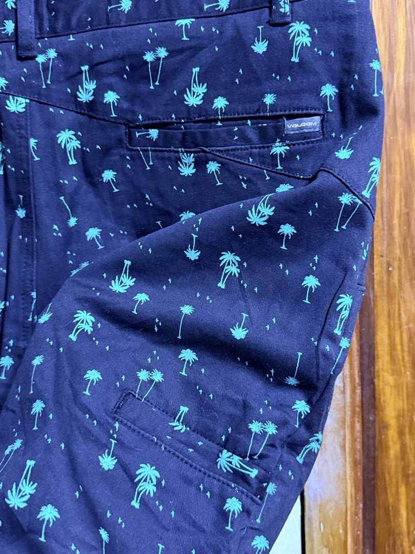 Volcom black Palm Tree Print Shorts Size 32 (Category: Shorts) located in Paete. Submitted by skydruemadison (Listing ID 1463689369, Image 3). Description: - Brand: Volcom - Color: Navy blue with teal palm tree print - Size: 32-34 L-21 - Closure: Button and zip - Pockets: Front, back, and side cargo pocket - Style: Casual wear, beachwear.