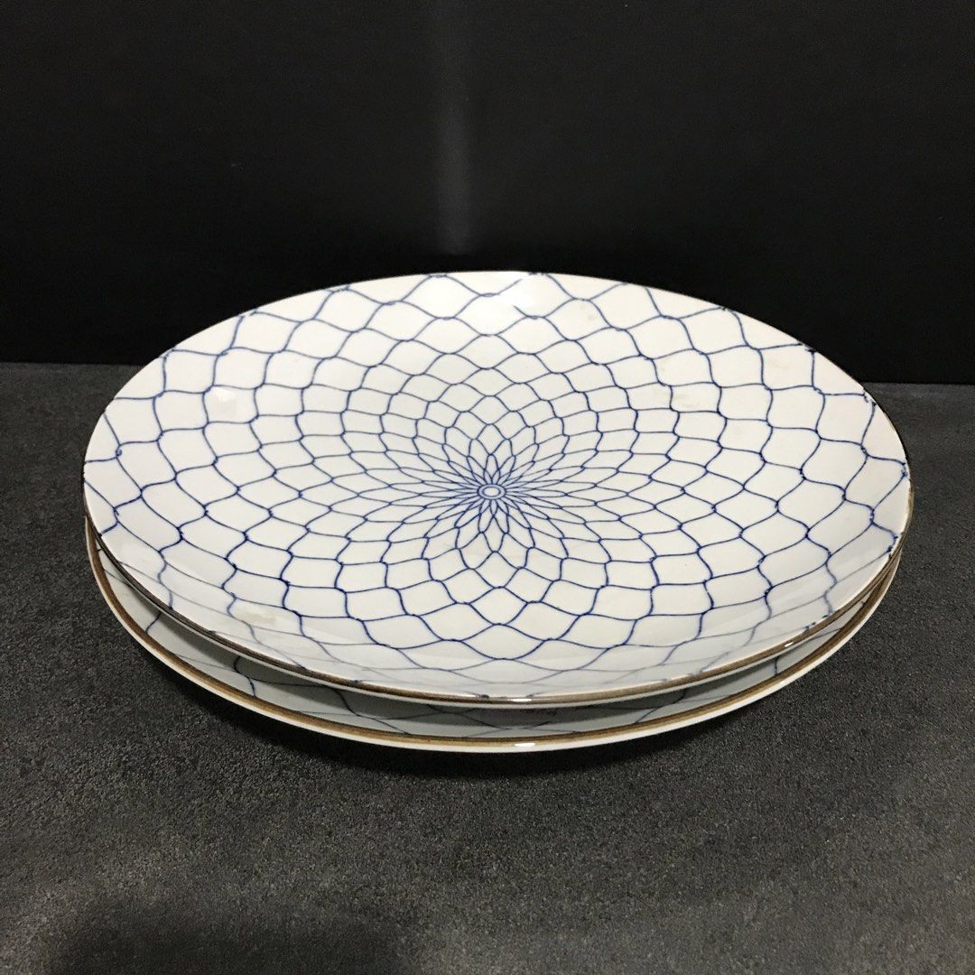 White Ceramic Plates with Blue Geometric Pattern (Category: Dinnerware & Cutlery) located in Baao. Submitted by all.things.japan (Listing ID 1463585745, Image 2). Description: 11.0 inches diameter P240.00 each - White base with striking blue geometric pattern - Subtle gold trim on edges - Ideal for serving or decorative display - One plate features a blue stamp on the back - Adds elegance to any kitchen or dining setting.