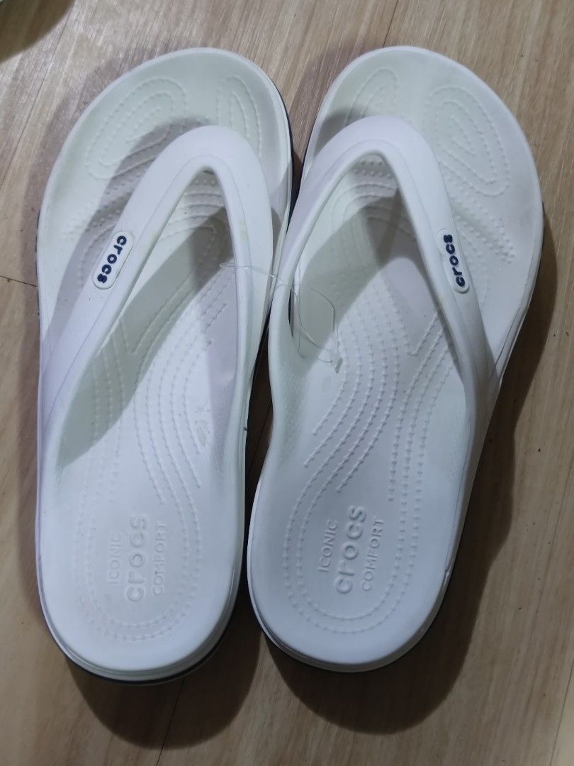 White Crocs Flip-Flops (Category: Slippers & Slides) located in Dagupan City. Submitted by jhazrightshop (Listing ID 1463691738, Image 2). Description: - Iconic white Crocs flip-flops - Experience classic Crocs comfort - Easy slip-on and off design - Perfect for everyday casual wear - Features Crocs logo and size details on sole - Crocs branding visible on the sides.