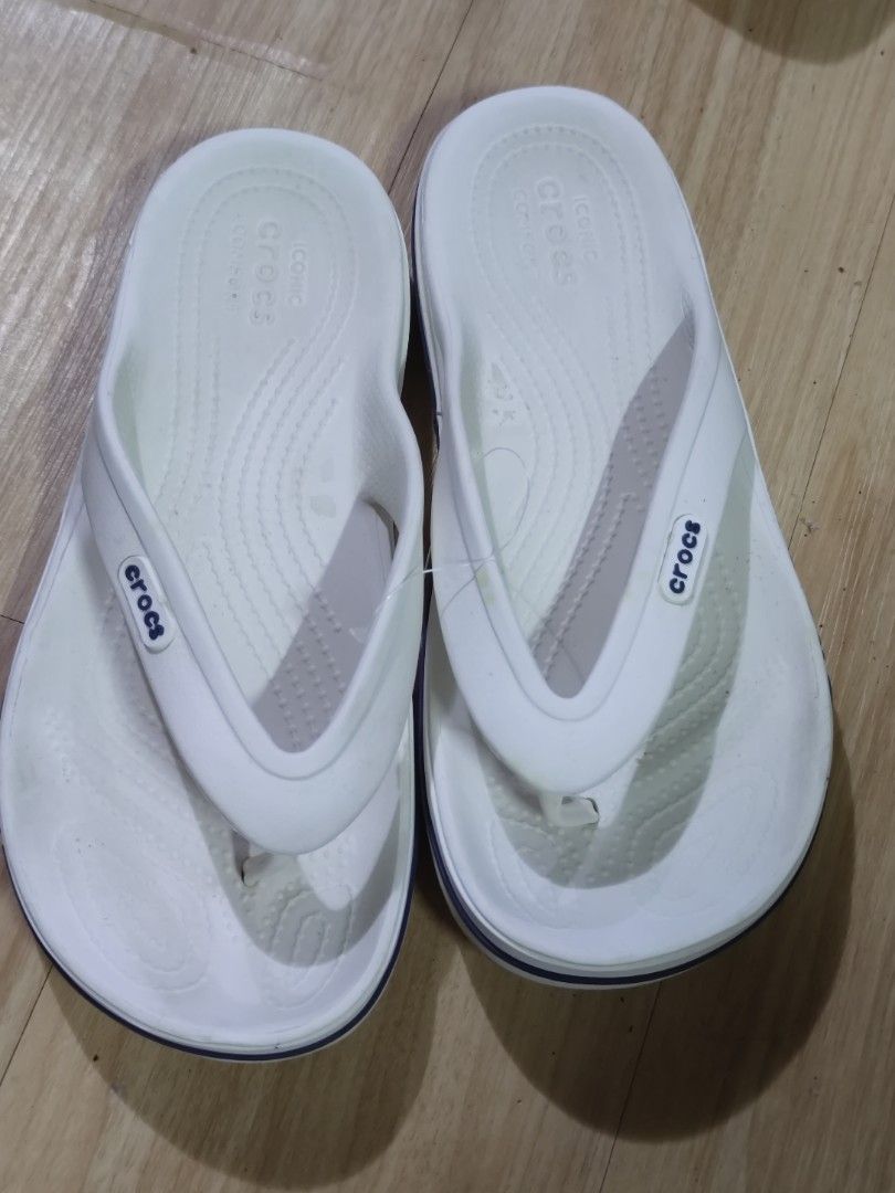 White Crocs Flip-Flops (Category: Slippers & Slides) located in Dagupan City. Submitted by jhazrightshop (Listing ID 1463691738, Image 1). Description: - Iconic white Crocs flip-flops - Experience classic Crocs comfort - Easy slip-on and off design - Perfect for everyday casual wear - Features Crocs logo and size details on sole - Crocs branding visible on the sides.