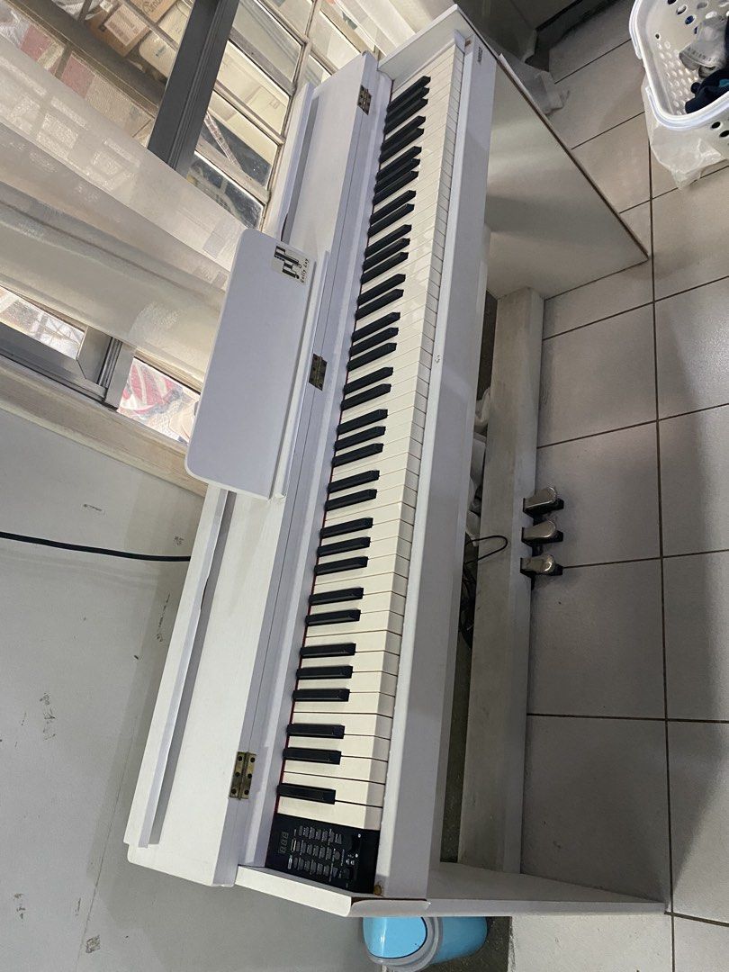 White Digital Piano with Pedals and USB (Category: Musical Instruments) located in Pasig City. Submitted by ayi017 (Listing ID 1463605407, Image 1). Description: - White 88-key digital piano - Includes three pedals - USB connectivity for recording and playback - Rhythm and tone functions included - Ideal for learning or practice - Selling as is.