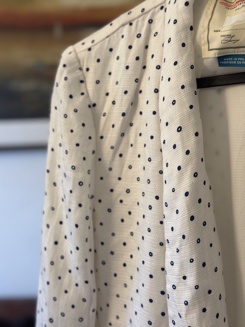 White Polka Dot Blazer Jacket (Category: Coats, Jackets and Outerwear) located in Manila. Submitted by timelessfindsbyjoann (Listing ID 1463710099, Image 3). Description: - White blazer with classic navy polka dots - Open front design with elegant draped lapel - Features functional front pockets - Versatile piece: dress up or down - Ideal for layering over tops or dresses - Proudly made in the Philippines.