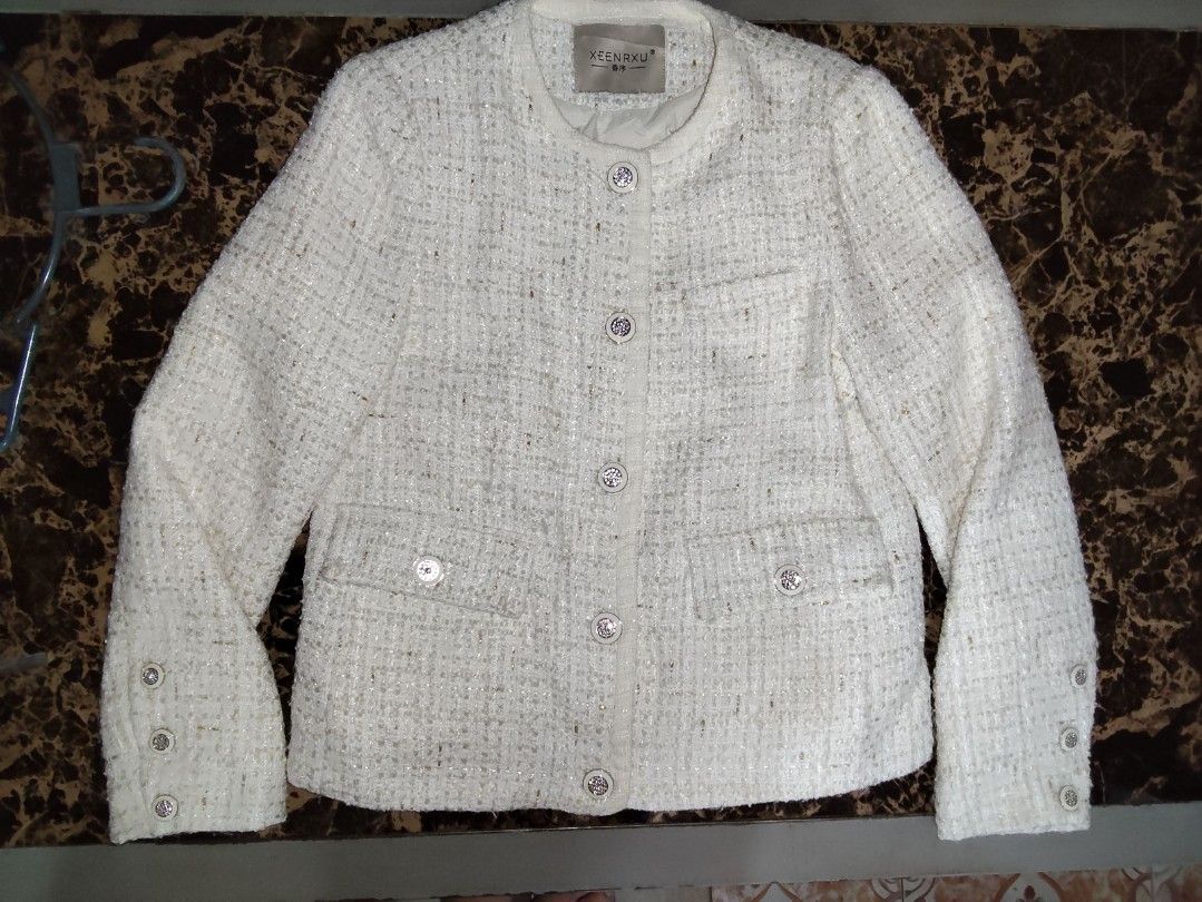White Tweed Jacket with Silver Buttons (Category: Coats, Jackets and Outerwear) located in Manila. Submitted by chocobutternut_ (Listing ID 1463687549, Image 1). Description: - Elegant white tweed jacket with a textured weave and subtle metallic threads. - Classic round neckline with a convenient button-up front. - Two stylish flap pockets on the chest. - Functional buttons on the cuffs. - Fully lined for a comfortable fit. - Perfect for both cas