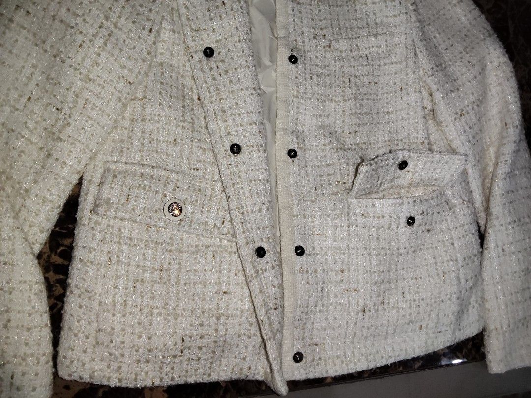 White Tweed Jacket with Silver Buttons (Category: Coats, Jackets and Outerwear) located in Manila. Submitted by chocobutternut_ (Listing ID 1463687549, Image 3). Description: - Elegant white tweed jacket with a textured weave and subtle metallic threads. - Classic round neckline with a convenient button-up front. - Two stylish flap pockets on the chest. - Functional buttons on the cuffs. - Fully lined for a comfortable fit. - Perfect for both cas