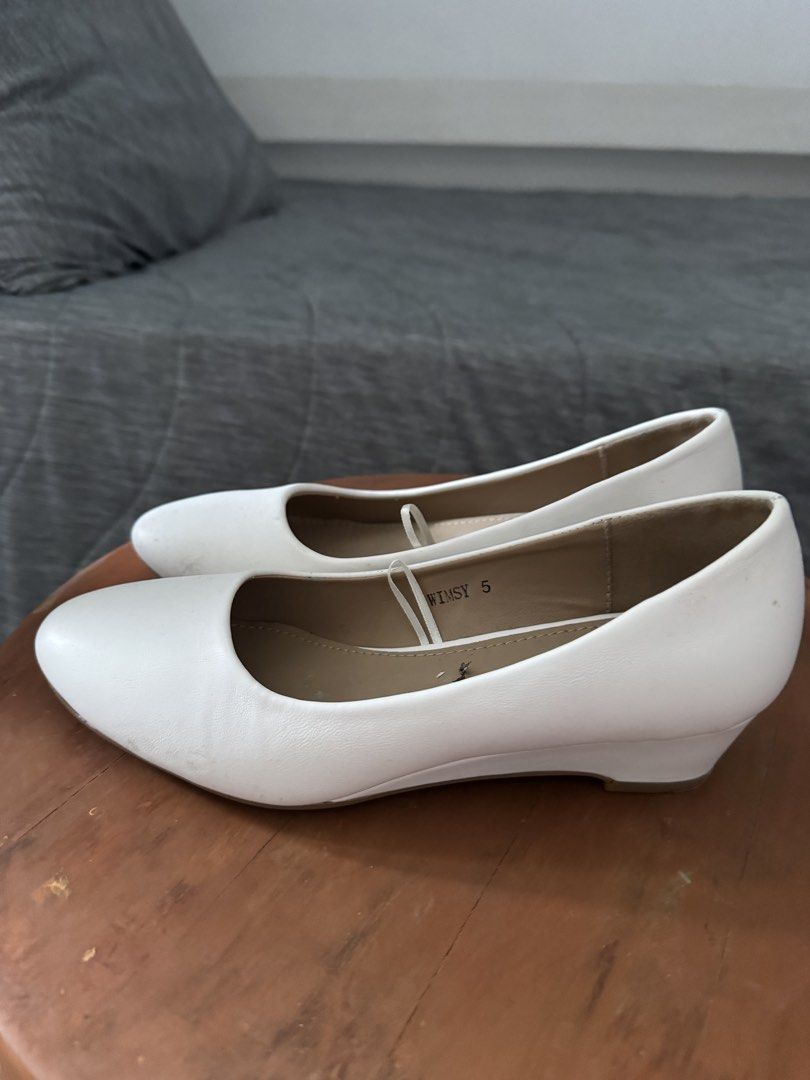 White Wedge Heels Size 5 (Category: Wedges) located in Las Pinas. Submitted by megalleon8 (Listing ID 1463684429, Image 2). Description: - Brand: Whimsy - Style: White Wedge Heels - Size: 5 - Type: Slip-on - Sole Color: Brown - Condition: Like new, price tag still attached, minimal signs of wear. - 1x lang ginamit, nakalimutan tanggalin yung tag price 😄 - Need idikit yung front part ng soles.