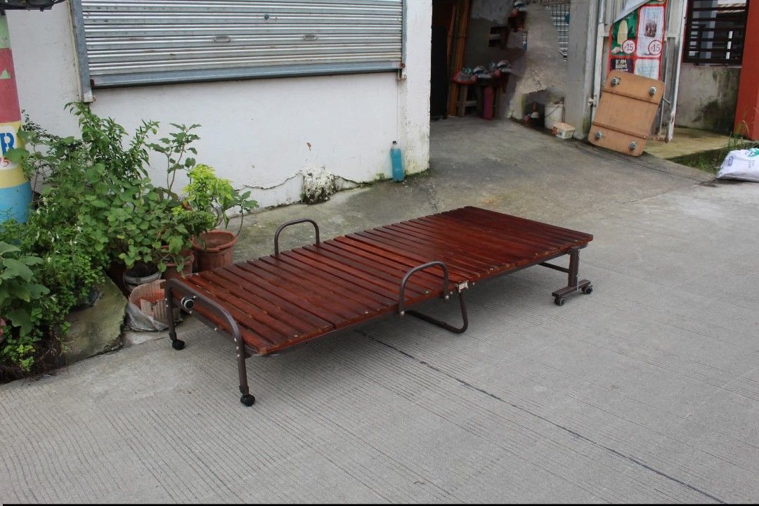 Wooden Folding bed (Category: Other Home Furniture) located in Meycauayan. Submitted by marygracecasimiro (Listing ID 1463629713, Image 2). Description: Folding Wooden Slatted Bed Base with Wheels Breathable sunoko-style platform, sturdy metal frame, integrated mattress guard rails and caster wheels for easy mobility. Folds compactly for convenient storage and is perfect for use with a mattress, futon or cushion pad L:36 • W:79 • H:12 inches 6,00