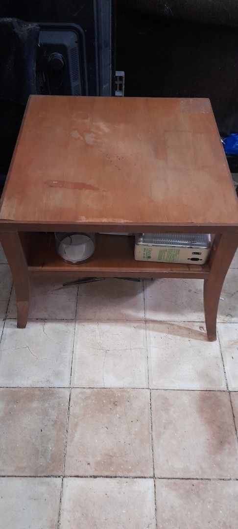 Wooden Side Table with Shelf (Category: Tables & Sets) located in Valenzuela. Submitted by newbear.425b6e (Listing ID 1463594008, Image 2). Description: - Sturdy wooden side table with a beautiful natural finish. - Two shelves provide ample storage space. - Elegant tapered legs add a stylish touch. - Ideal for use as a bedside table or next to your sofa. - Shows some minor marks on the surface, consistent with light use. - Overall, a solid and re