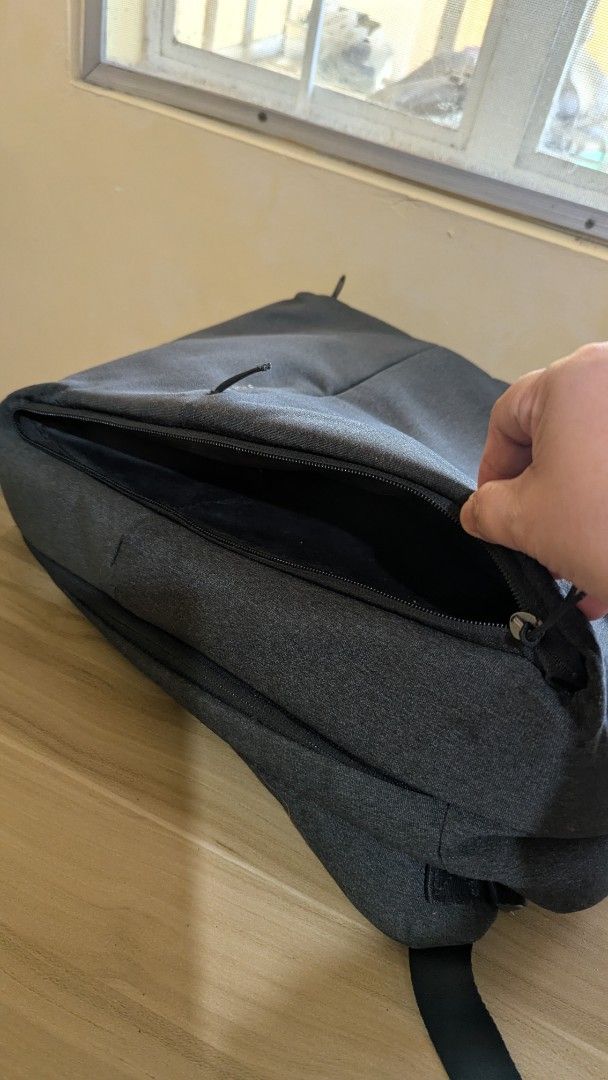 Xiaomi Backpack (Category: Backpacks) located in Paranaque City. Submitted by lai_francisco (Listing ID 1463742086, Image 3). Description: a dark gray Xiaomi Mi City Backpack 2 featuring a minimalist design and a front zippered pocket with "URBAN LIFE STYLE" branding..