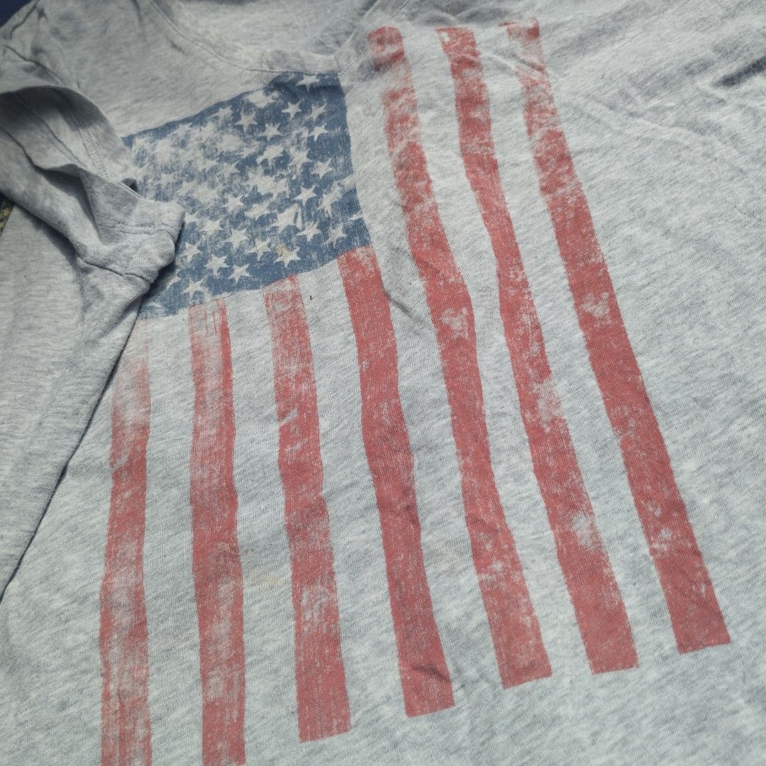 Y2K Shirt US Flag V-neck (Category: Tshirts & Polo Shirts ) located in San Pedro. Submitted by cooloset.mp4official (Listing ID 1463630291, Image 2). Description: Medium-Large Not Bacon Neck 💯 Y2k print, Good partner with Bootcut Jeans issue: Last 2 pictures, Stain and Paint (unnoticeable) Loc. Laguna.