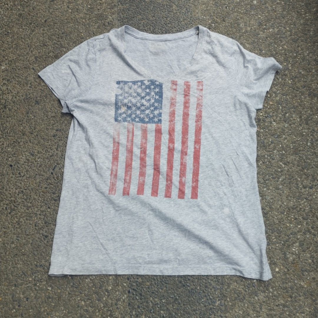 Y2K Shirt US Flag V-neck (Category: Tshirts & Polo Shirts ) located in San Pedro. Submitted by cooloset.mp4official (Listing ID 1463630291, Image 1). Description: Medium-Large Not Bacon Neck 💯 Y2k print, Good partner with Bootcut Jeans issue: Last 2 pictures, Stain and Paint (unnoticeable) Loc. Laguna.