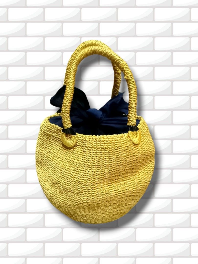 Yellow Smiley Face Straw Bag with Navy Blue Lining (Category: Shoulder Bags) located in Aguinaldo. Submitted by ukayandthrift (Listing ID 1463578257, Image 3). Description: - Adorable yellow straw bag - Features a cheerful smiley face design - Navy blue stars serve as eyes - Lined with navy blue fabric - Woven straw handles - Ideal for a fun, casual look - Perfect for carrying your essentials.