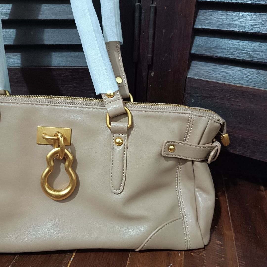 Yvette Elongated Tote Bag - Beige (Category: Tote Bags) located in Caloocan City. Submitted by hiraya16 (Listing ID 1463727870, Image 3). Description: - Beige Yvette Elongated Tote Bag - Features gold hardware and a unique charm detail - Secure top zip closure - Handles still have protective plastic wrap, indicating it's never been used - 100% Original.