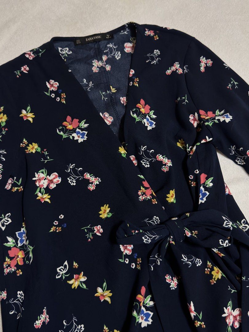 Zara Basic Navy Floral Wrap Dress with Bell Sleeves (Category: Dresses) located in Cebu City. Submitted by eynjlin (Listing ID 1463688423, Image 2). Description: - Zara Basic navy blue wrap dress - Pretty all-over floral print with colorful small flowers - Long bell sleeves - Tie waist - Slightly ruffled hemline - Perfect for casual outings or dressing up.