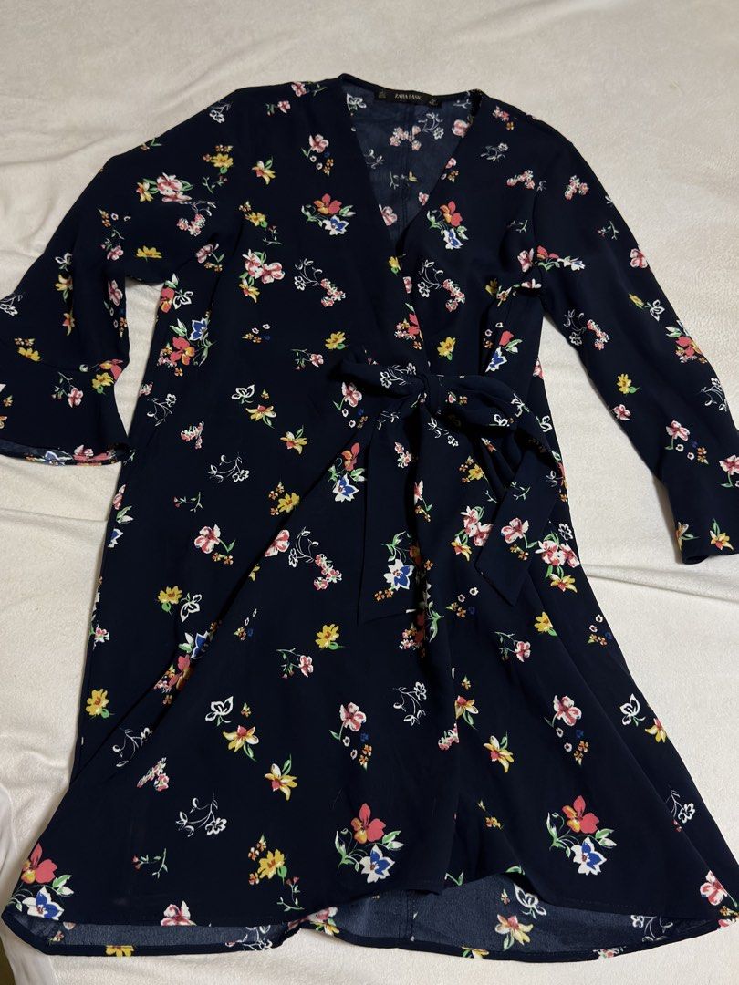 Zara Basic Navy Floral Wrap Dress with Bell Sleeves (Category: Dresses) located in Cebu City. Submitted by eynjlin (Listing ID 1463688423, Image 1). Description: - Zara Basic navy blue wrap dress - Pretty all-over floral print with colorful small flowers - Long bell sleeves - Tie waist - Slightly ruffled hemline - Perfect for casual outings or dressing up.