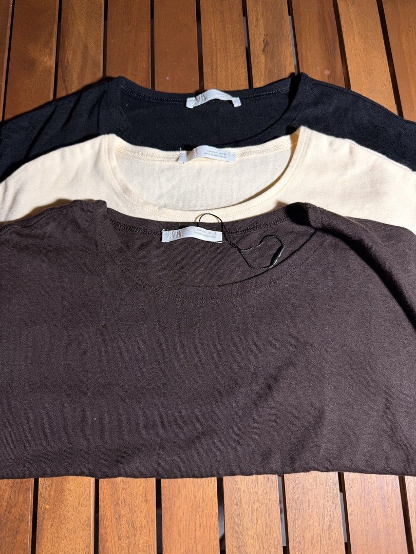 Zara Basic T-shirts Bundle (Black, Cream, Brown) (Category: Shirts) located in Tuguegarao City. Submitted by joysmithznjo (Listing ID 1463559007, Image 1). Description: - Fixed price, 350 if each - Bundle of three basic Zara t-shirts - Colors: Black, Cream, Dark Brown - Style: Crew neck, short sleeves - Material: Soft, comfortable fabric - Fit: All size L - Perfect for everyday wear or layering - Selling as a set.