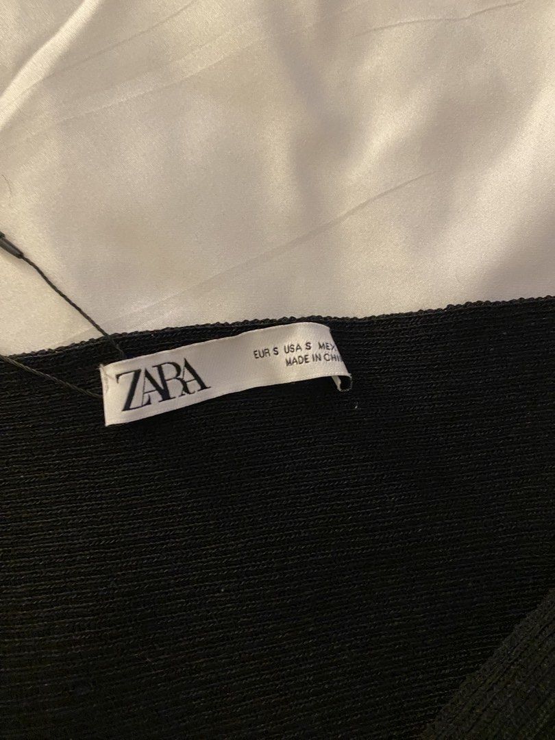 Zara Black Knit Twist Front Top Size S (Category: Blouses) located in Quezon City. Submitted by myshoppingaccount24 (Listing ID 1463628058, Image 2). Description: - Zara black knit top - Size S - Features a twist detail at the front - Short sleeves - Cropped style - Original tag still attached - Original price: 1595 PHP.