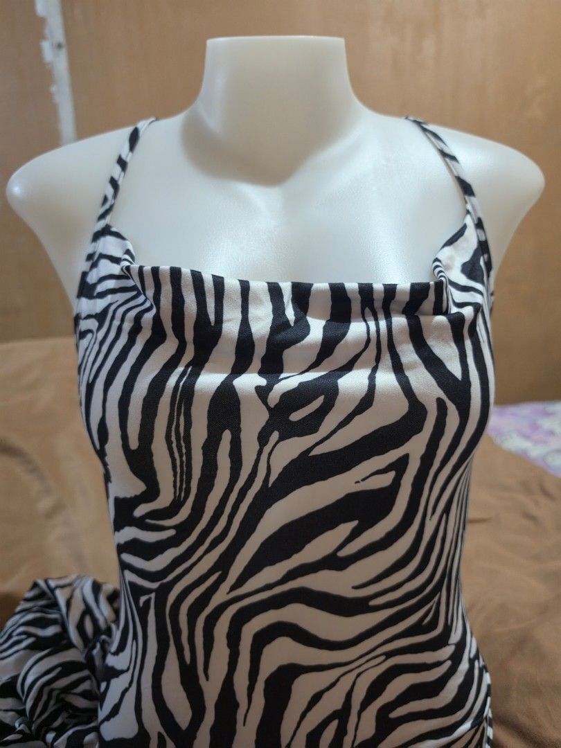 Zebra Print Halter Neck Maxi Dress (Category: Dresses) located in Malabon City. Submitted by lpzangie (Listing ID 1463704393, Image 1). Description: - zebra print - Halter neck with thin straps - Unique criss-cross back strap design - Flowy and lightweight fabric - Easy to wear and style.