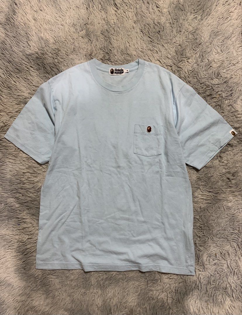 A Bathing Ape Light Blue Pocket Tee (Category: Tshirts & Polo Shirts ) located in Cebu City. Submitted by ninyothrift (Listing ID 1463892550, Image 1). Description: - Light blue A Bathing Ape (BAPE) T-shirt - Size Medium (M) - Iconic ape head logo on left chest pocket - Ideal for everyday casual wear - Dimes:22.5x28 - Excellent condition - No issue - Need wash may kunting yellow stain - Dipo yan discoloration .