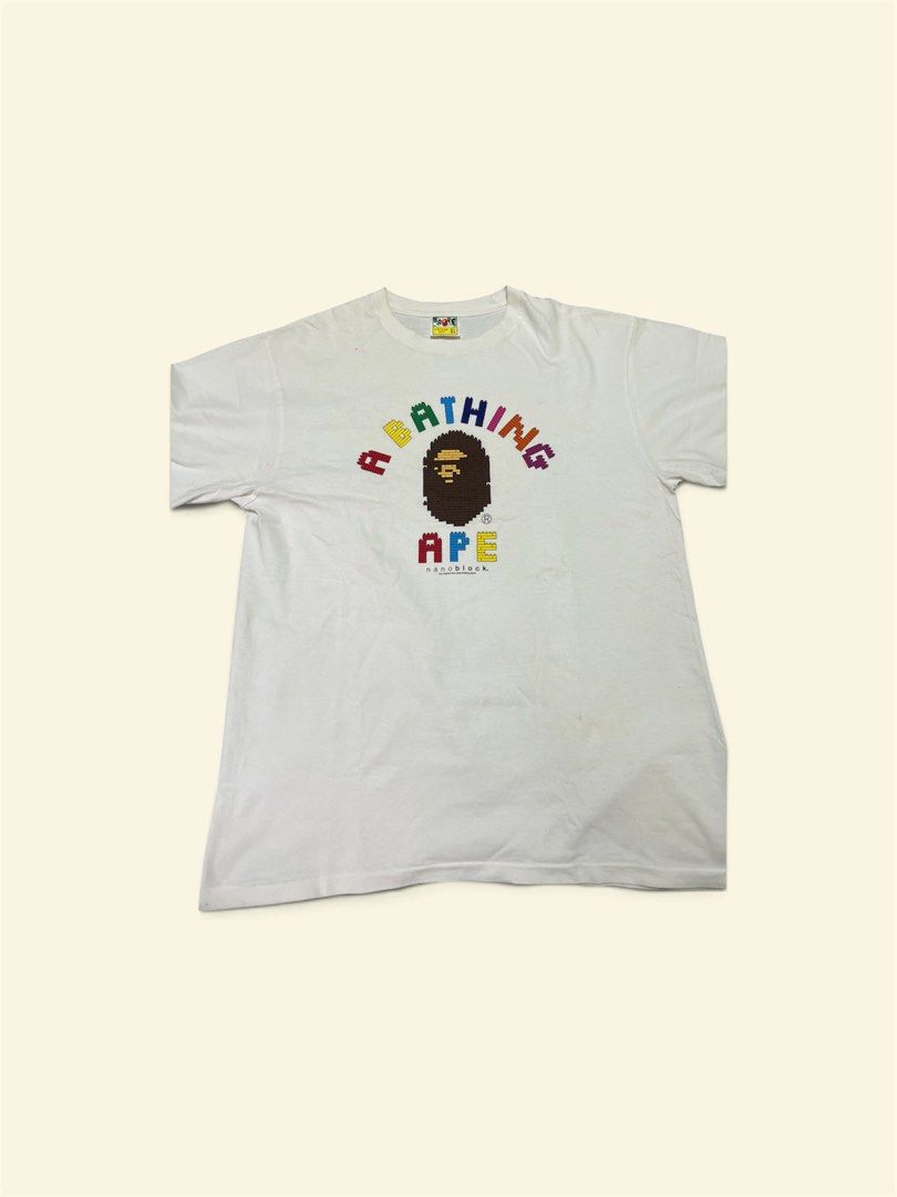 A Bathing Ape x Nanoblock White T-shirt (Category: Activewear) located in San Juan City. Submitted by thrifttolife (Listing ID 1463776162, Image 1). Description: - White A Bathing Ape (BAPE) T-Shirt - Collaboration with Nanoblock - Features iconic colorful pixelated Bape head and 'A BATHING APE' text L: 74 cm W: 55 cm .