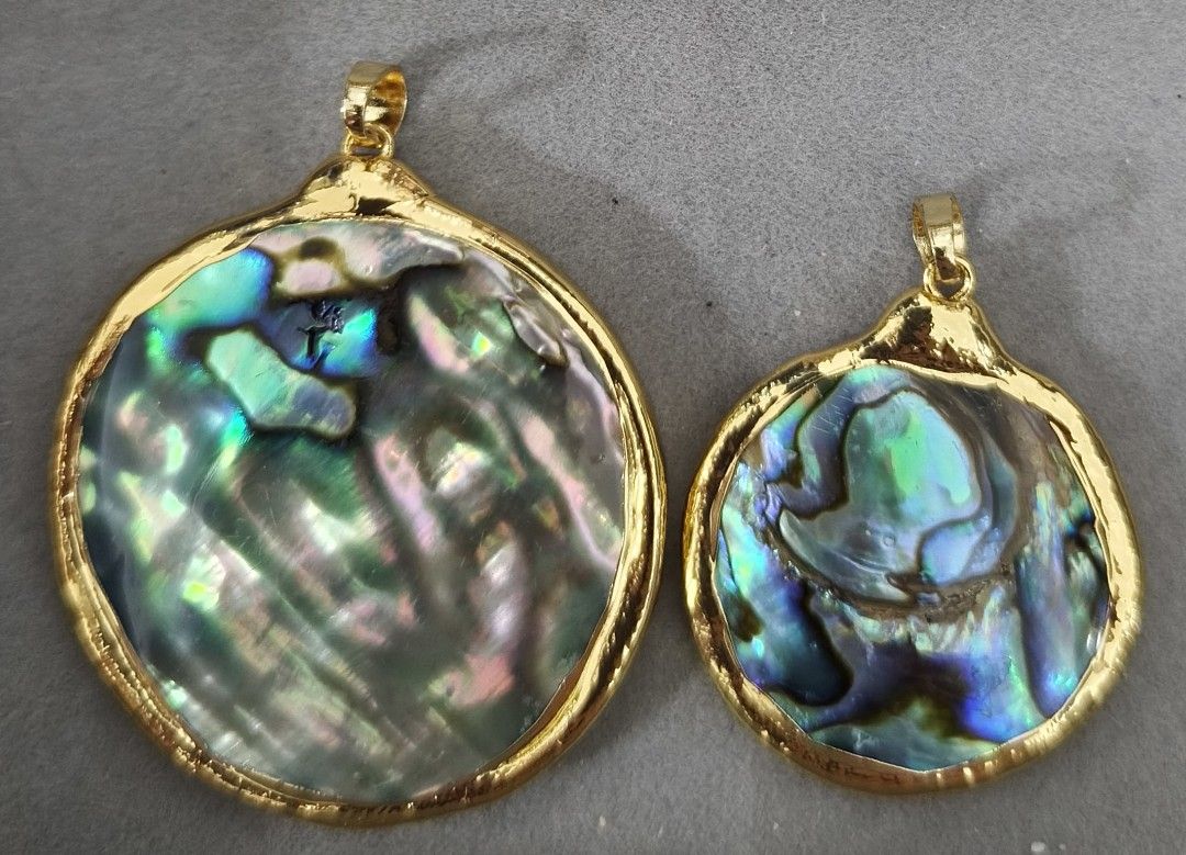 Abalone Shell Pendant in Brass Setting (Category: Necklaces) located in Batangas. Submitted by decluttering_bliss (Listing ID 1463826774, Image 1). Description: - Set of 2 abalone shell pendants for 900, if small pendant only, 396, if big pendant only, 650. - Brass setting - Natural iridescent colors - One round pendant, one slightly irregular pendant - Ideal for DIY jewelry projects - Great addition to any shell collection - Each piece features 