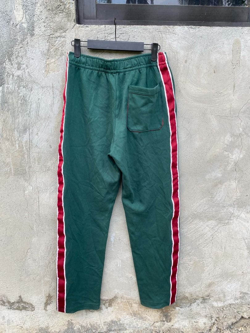Acne Studios Green Sweatpants with Side Stripe (Category: Joggers) located in Andop. Submitted by arahgain096227 (Listing ID 1463885560, Image 1). Description: - Authentic Acne Studios green sweatpants - Features a distinctive red and white stripe down the side - Comfortable drawstring waist with eye-catching pink and red accents - Small Acne Studios logo patch on the right leg - Perfect blend of comfort and style.