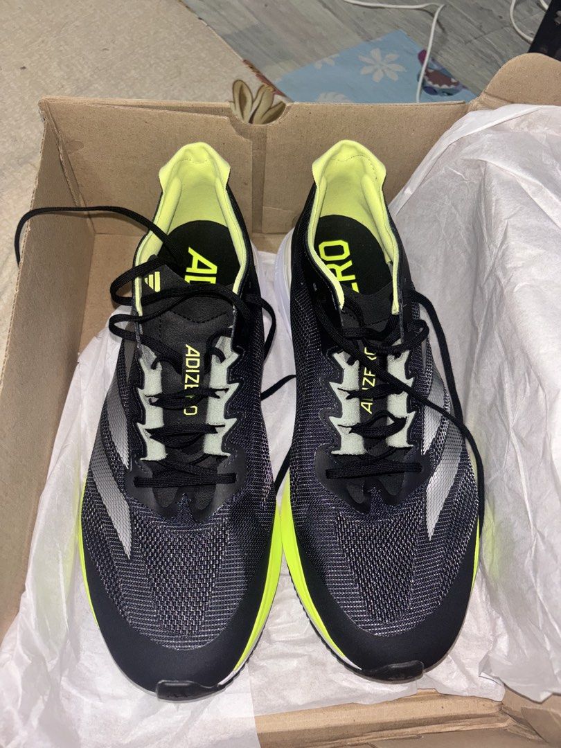 Adidas Adizero Boston 12 (Category: Sneakers) located in Paranaque City. Submitted by gingerman (Listing ID 1463935196, Image 2). Description: - Adidas Adizero Boston 12 running shoes - Color: Black with neon yellow accents - Key Features: Lightweight, designed for speed - Ideal for: Marathon runners, serious athletes - Condition: Soles look clean - Includes: Original box.