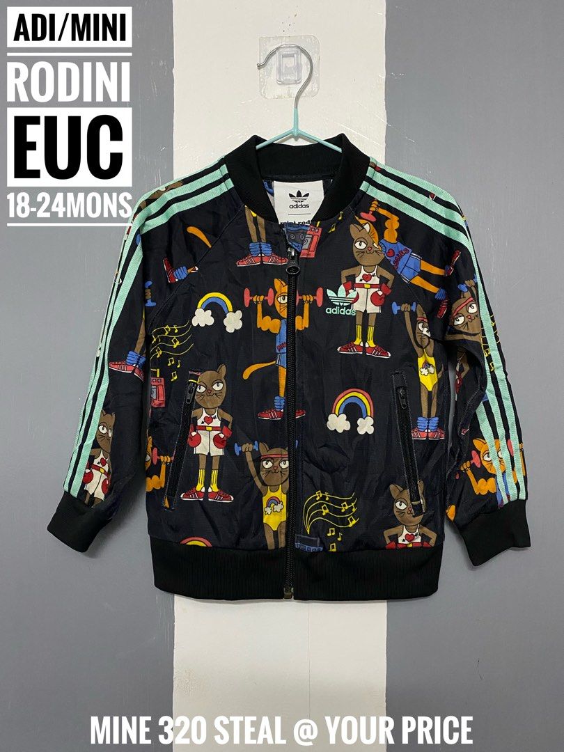 Adidas Mini Rodini (Category: Babies & Kids Fashion) located in Paranaque City. Submitted by shiney10 (Listing ID 1463904947, Image 1). Description: - Adorable Mini Rodini x Adidas collaboration track jacket. - Features a playful all-over cat print. - Ideal for babies aged 18-24 months. - A fantastic find for your little fashionista!.