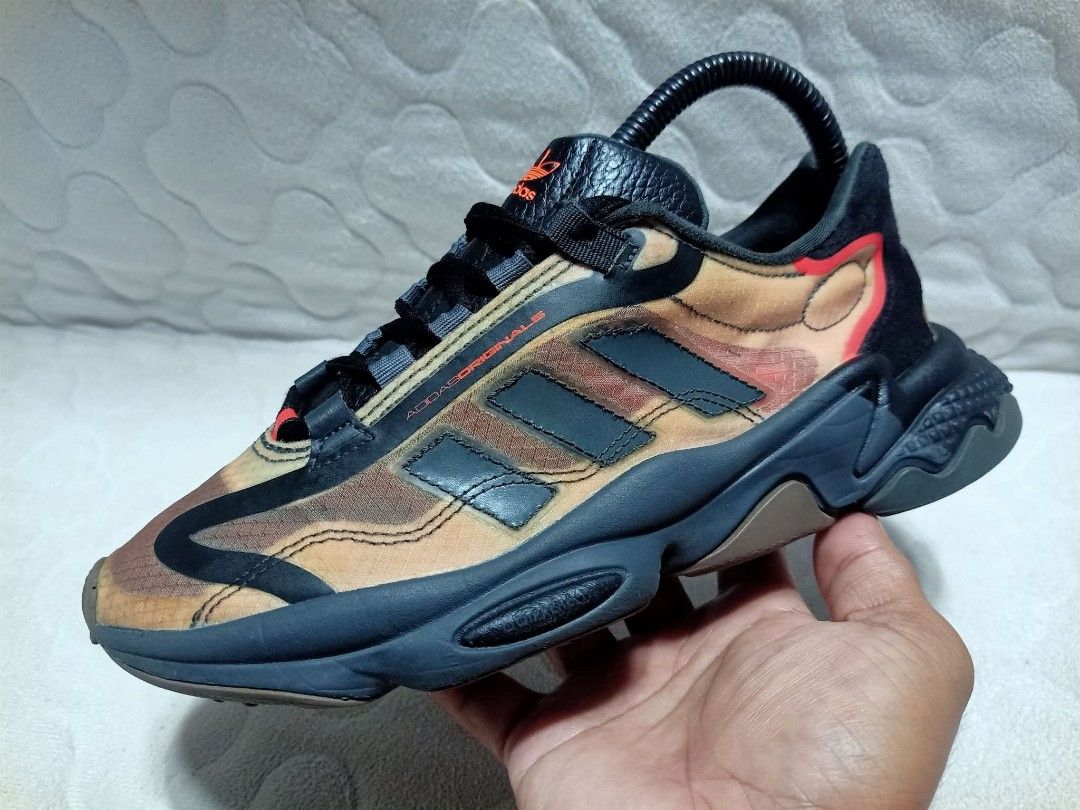 Adidas Ozweego Camo Sneakers (Category: Sneakers) located in Manila. Submitted by urbantreasures.101 (Listing ID 1463788766, Image 2). Description: - Adidas Ozweego sneakers - Stylish camouflage pattern - Black laces - Dark grey sole - Orange Adidas logo on tongue - Statement piece for casual wear ORIGINAL , PRELOVED , DECLUTTERING , NO ISSUE 😊 CAN SHIP NATIONWIDE LOCATION: UMAPAD MANDAUE CITY , CEBU.
