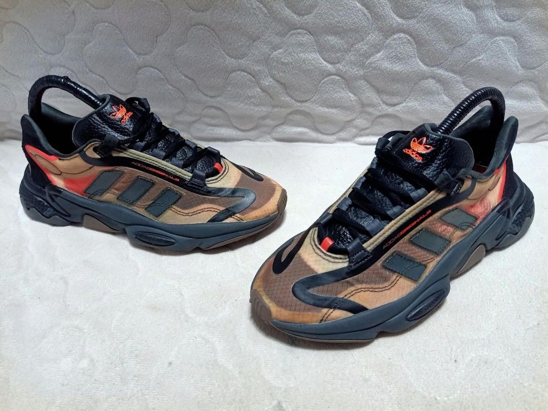 Adidas Ozweego Camo Sneakers (Category: Sneakers) located in Manila. Submitted by urbantreasures.101 (Listing ID 1463788766, Image 3). Description: - Adidas Ozweego sneakers - Stylish camouflage pattern - Black laces - Dark grey sole - Orange Adidas logo on tongue - Statement piece for casual wear ORIGINAL , PRELOVED , DECLUTTERING , NO ISSUE 😊 CAN SHIP NATIONWIDE LOCATION: UMAPAD MANDAUE CITY , CEBU.