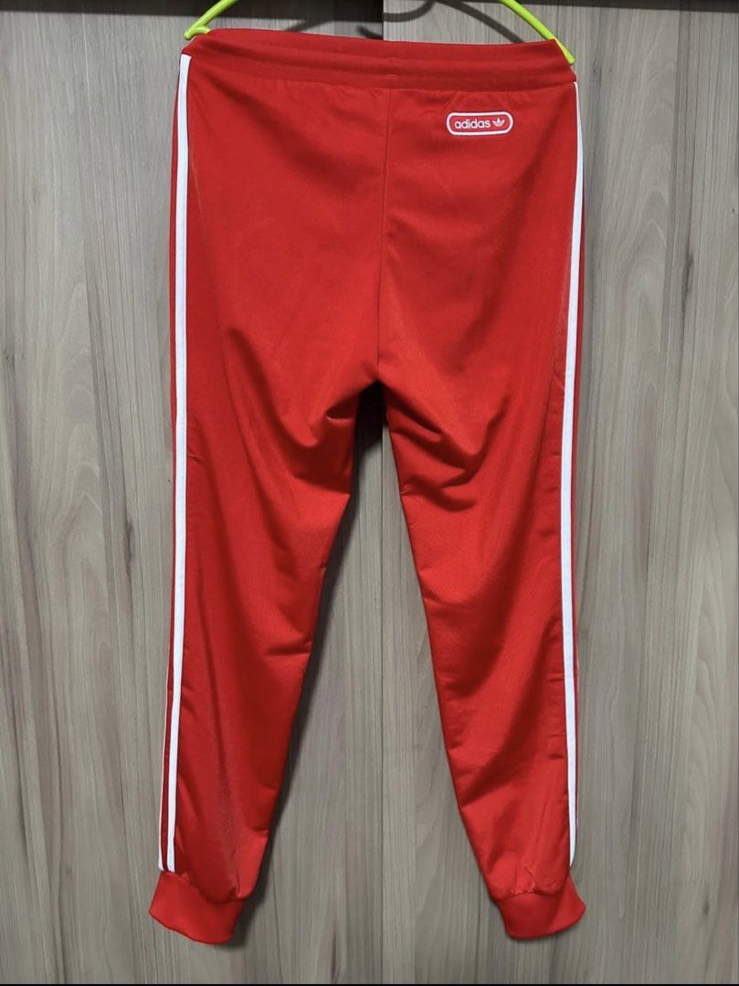Adidas Red Track Pants with White Stripes (Category: Joggers) located in Paranaque City. Submitted by musikisellerph (Listing ID 1463874490, Image 2). Description: For Sale: ADIDAS ORIGINALS Men’s SST Track Red Pants Size: Small Fits: 28-32 / 175cm height - Classic Adidas track pants in vibrant red - Iconic white three stripes down the sides - Comfortable elastic waistband with drawstring - Cuffed ankles for a snug fit - Versatile for sports or e