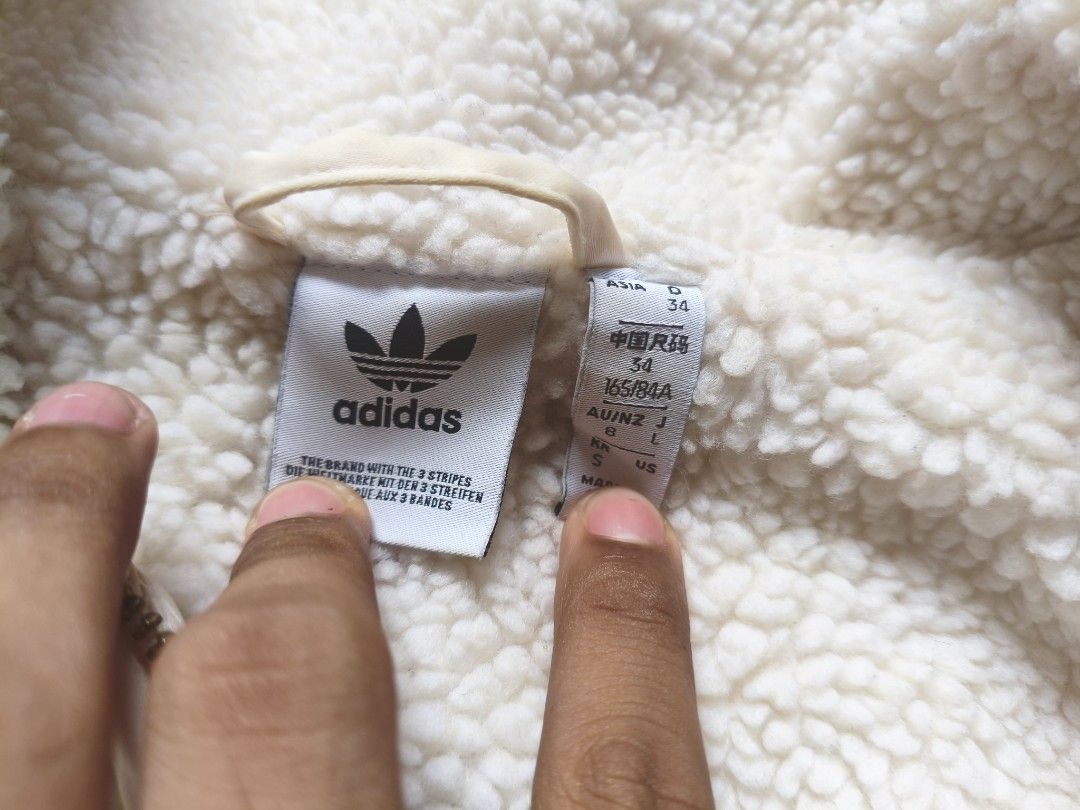 Adidas Sherpa Fleece Jacket Beige (Category: Coats, Jackets and Outerwear) located in Manila. Submitted by grims_garments (Listing ID 1463816477, Image 2). Description: - Super cozy Adidas sherpa fleece jacket - Creamy beige color - Full zip front with a gold zipper - Two chest pockets - Two side pockets - Small embroidered Adidas logo on chest pocket - Ideal for keeping warm.