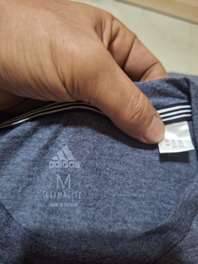 Adidas T-shirt with 3 Stripes (Category: Tshirts & Polo Shirts ) located in Mabalacat. Submitted by jhaycore05 (Listing ID 1463863716, Image 2). Description: - Classic Adidas T-shirt - Color: Dark Grey/Navy Blue - Iconic three stripes on sleeves - Comfortable for everyday wear - Suitable for sports or casual outings - Made in Vietnam dimes: 19.5x28 excellwnt condition no issue.