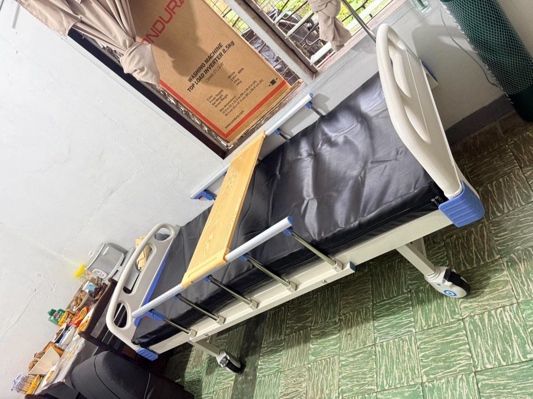 Adjustable Hospital Bed with Mattress and Tray (Category: Bed Frames & Mattresses) located in Manila. Submitted by rosel2001 (Listing ID 1463768013, Image 2). Description: - Adjustable hospital bed - Includes comfortable mattress - Comes with a side tray - Equipped with wheels for easy mobility - Ideal for home care needs - Ready for pickup.