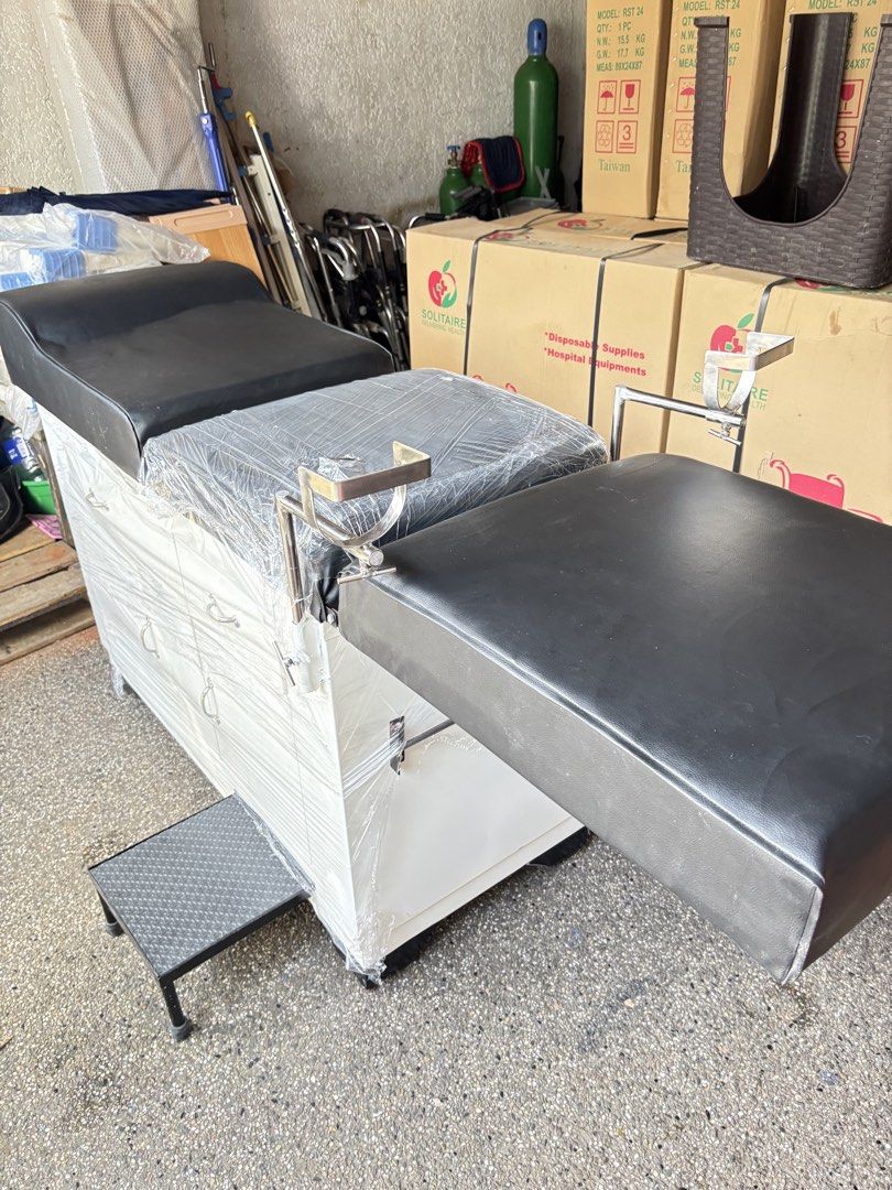 Adjustable Medical Examination Table with Storage Drawers (Category: Medical Supplies & Tools) located in Manila. Submitted by rosel2001 (Listing ID 1463768762, Image 1). Description: - Adjustable medical examination table - Black padded upholstery - White cabinet base with storage drawers - Includes a small step stool - Some protective plastic wrap still on - Ideal for clinics or home use - Ready for pickup.