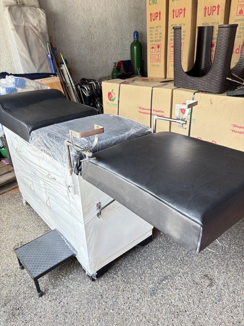 Adjustable Medical Examination Table with Storage Drawers (Category: Medical Supplies & Tools) located in Manila. Submitted by rosel2001 (Listing ID 1463768762, Image 2). Description: - Adjustable medical examination table - Black padded upholstery - White cabinet base with storage drawers - Includes a small step stool - Some protective plastic wrap still on - Ideal for clinics or home use - Ready for pickup.