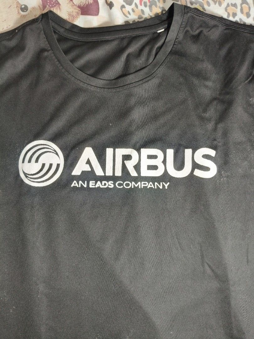Airbus Active-Dry T-Shirt (Category: Tshirts & Polo Shirts ) located in Lapu Lapu. Submitted by hooman422 (Listing ID 1463803915, Image 2). Description: - Black Airbus t-shirt - Features Airbus logo and 'AN EADS COMPANY' on the front - 'ACTIVE-DRY' printed on the back near the collar - Suitable for casual wear or sports activities.