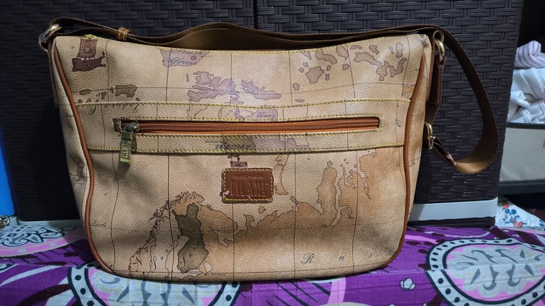 Alviero Martini Sling Bag (Category: Cross-body Bags) located in Quezon City. Submitted by 88bagelya_ni_rhen88 (Listing ID 1463757202, Image 1). Description: - Classic Alviero Martini sling / body bag - Iconic map print - Leather trim and strap - Zipper closure on front pocket - Main compartment with zipper closure - Great for everyday use .
