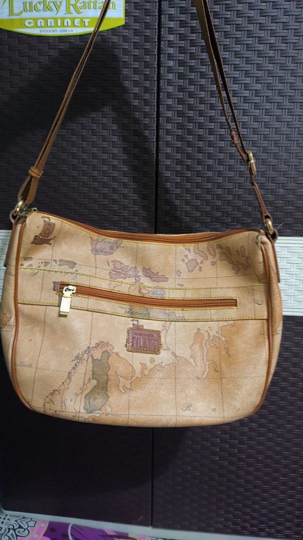 Alviero Martini Sling Bag (Category: Cross-body Bags) located in Quezon City. Submitted by 88bagelya_ni_rhen88 (Listing ID 1463757202, Image 2). Description: - Classic Alviero Martini sling / body bag - Iconic map print - Leather trim and strap - Zipper closure on front pocket - Main compartment with zipper closure - Great for everyday use .
