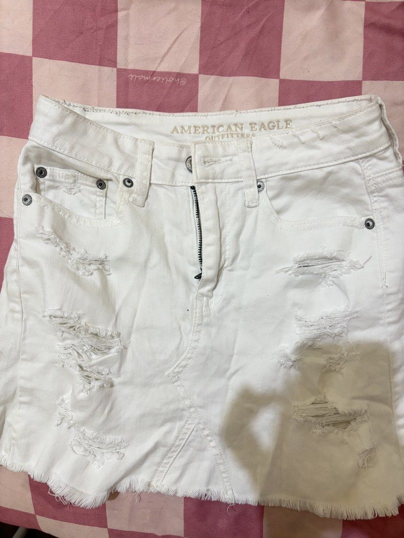 American Eagle White Ripped Denim Mini Skirt (Category: Skirts) located in Pasay City. Submitted by kikayfindsxs (Listing ID 1463826996, Image 1). Description: - White denim mini skirt from American Eagle Outfitters - Features distressed rips and a frayed hem - Classic five-pocket styling with a zip fly - Ideal for casual wear - Easy to pair with tops and sneakers.