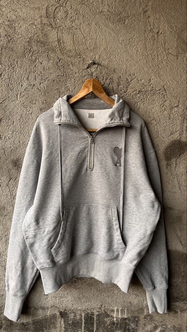 AMI Paris Grey Half Zip Sweatshirt (Category: Coats, Jackets and Outerwear) located in Cabuyao City. Submitted by bulandos (Listing ID 1463838703, Image 1). Description: - Grey AMI Paris sweatshirt - Size: S but large fittings - Signature Ami de Coeur logo embroidered on chest - Half zip closure with stand-up collar - Kangaroo pocket - Material: 100% organic cotton.