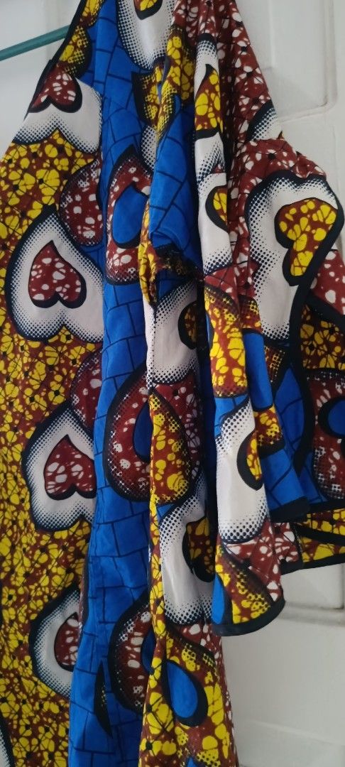 Ankara Print V-Neck Flutter Sleeve Top (Category: Blouses) located in Paranaque City. Submitted by yesyesyo (Listing ID 1463811265, Image 2). Description: - V-neck top with vibrant Ankara print - Features stylish flutter sleeves - Relaxed fit for comfort - Unique fabric pattern: mix of heart and geometric designs - Colors: yellow, blue, red, and white - Versatile: great for casual or dressed-up looks - Easy to pair with jeans or skirts -width 25 