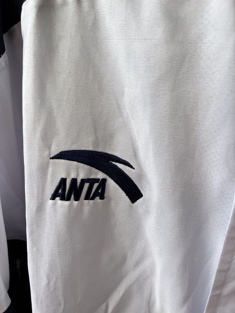 ANTA Windbreaker Jacket "LETRAN" (Category: Coats, Jackets and Outerwear) located in Taytay. Submitted by cside1900 (Listing ID 1463758746, Image 3). Description: - Navy and white ANTA windbreaker jacket - Features 'LETRAN' logo on the back - Cool embroidered graphic on the front chest - Full zip closure with snap buttons - Elasticated cuffs and hem - Ideal for casual wear or sports.