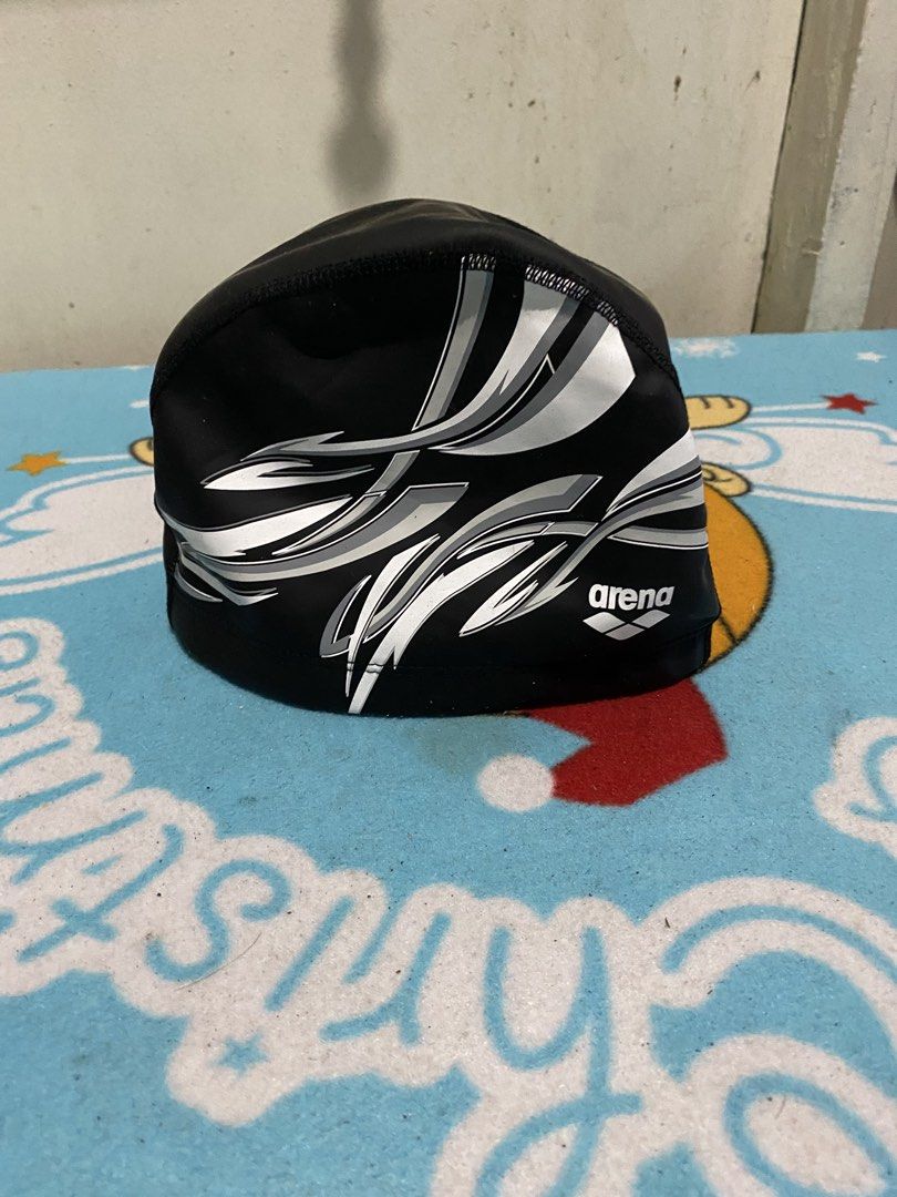 Arena Black Swim Cap with Graphic Design (Category: Caps & Hats) located in Manila. Submitted by resi.diaz (Listing ID 1463901868, Image 1). Description: - Arena swim cap in black - Features a cool white and grey graphic design - Protects hair from chlorine damage - Comfortable fit for regular use - Ideal for all your swimming sessions.