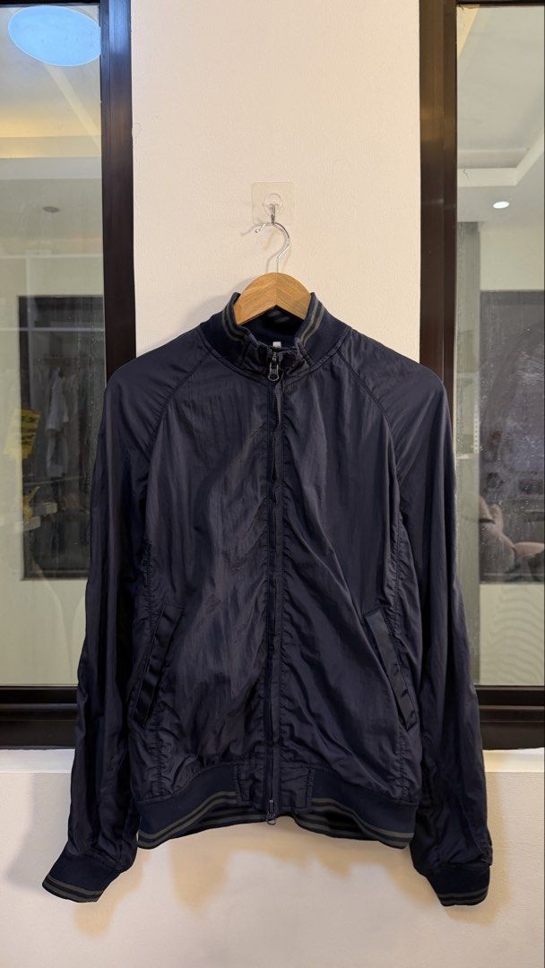 Armani Jeans Navy Bomber Jacket (Category: Coats, Jackets and Outerwear) located in Paranaque City. Submitted by mykapoynton (Listing ID 1463881670, Image 2). Description: Armani Jeans Navy Bomber Jacket - Lightweight material, ideal for layering - Features ribbed collar, cuffs, and hem - Zip-up front with convenient pockets - Classic bomber silhouette - Versatile for casual outfits.
