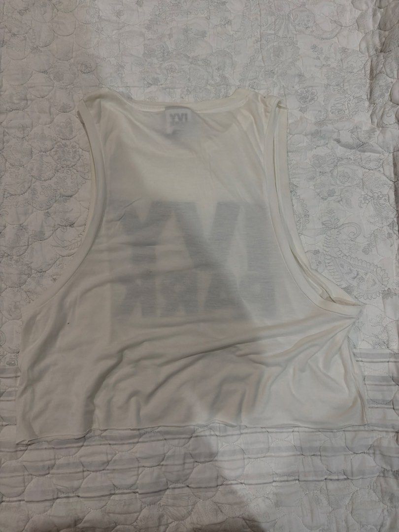 Authentic Ivy Park White Cropped Tank Top (Category: Sleeveless) located in Cagayan de Oro. Submitted by pamscloset8 (Listing ID 1463790953, Image 2). Description: - White cropped tank top from Ivy Park - Features bold Ivy Park logo on the front - Sleeveless design - Ideal for workouts or casual wear - Pairs well with leggings or shorts.