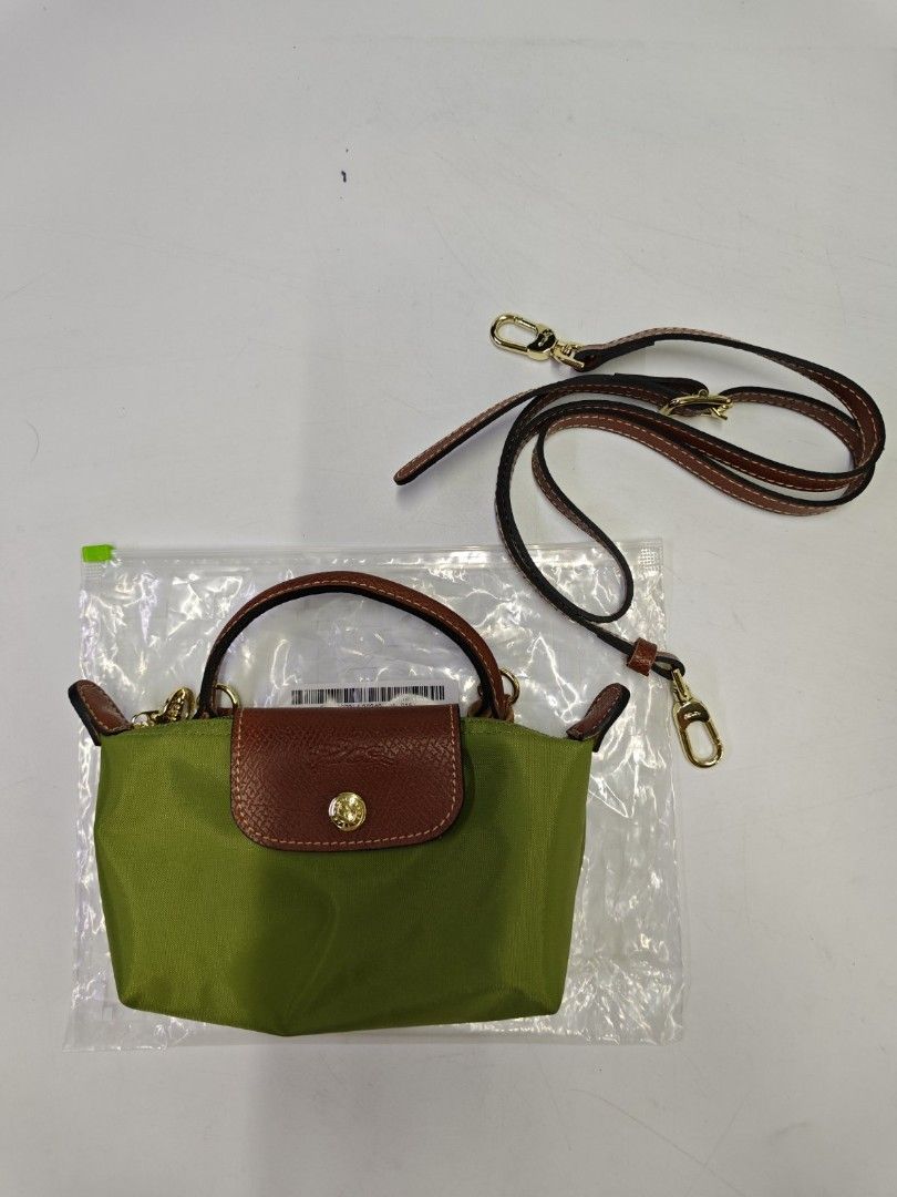 Authentic Longchamp Le Pliage Classic Mini Top Handle Bag with Sling (Category: Luxury Bags & Wallets) located in Quezon City. Submitted by hollowwillow (Listing ID 1463154302, Image 3). Description: New arrival! - Cute Longchamp bags - mini top handle size - Available in multiple colors - can hold an iphone pro max - Lightweight and durable nylon material - Features genuine leather trim and detachable strap.
